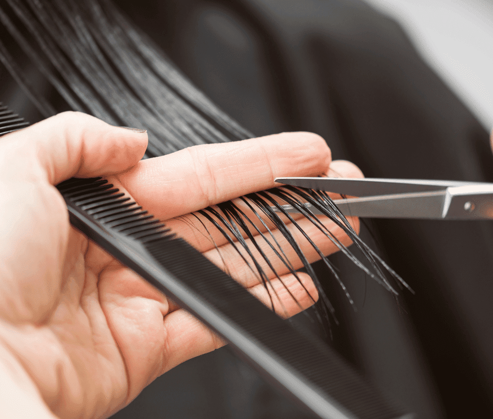 Close-up of a haircut in progress with scissors and comb.